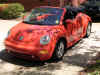 Oranje Volkswagen New Beetle