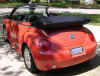 Oranje Volkswagen New Beetle cabriolet